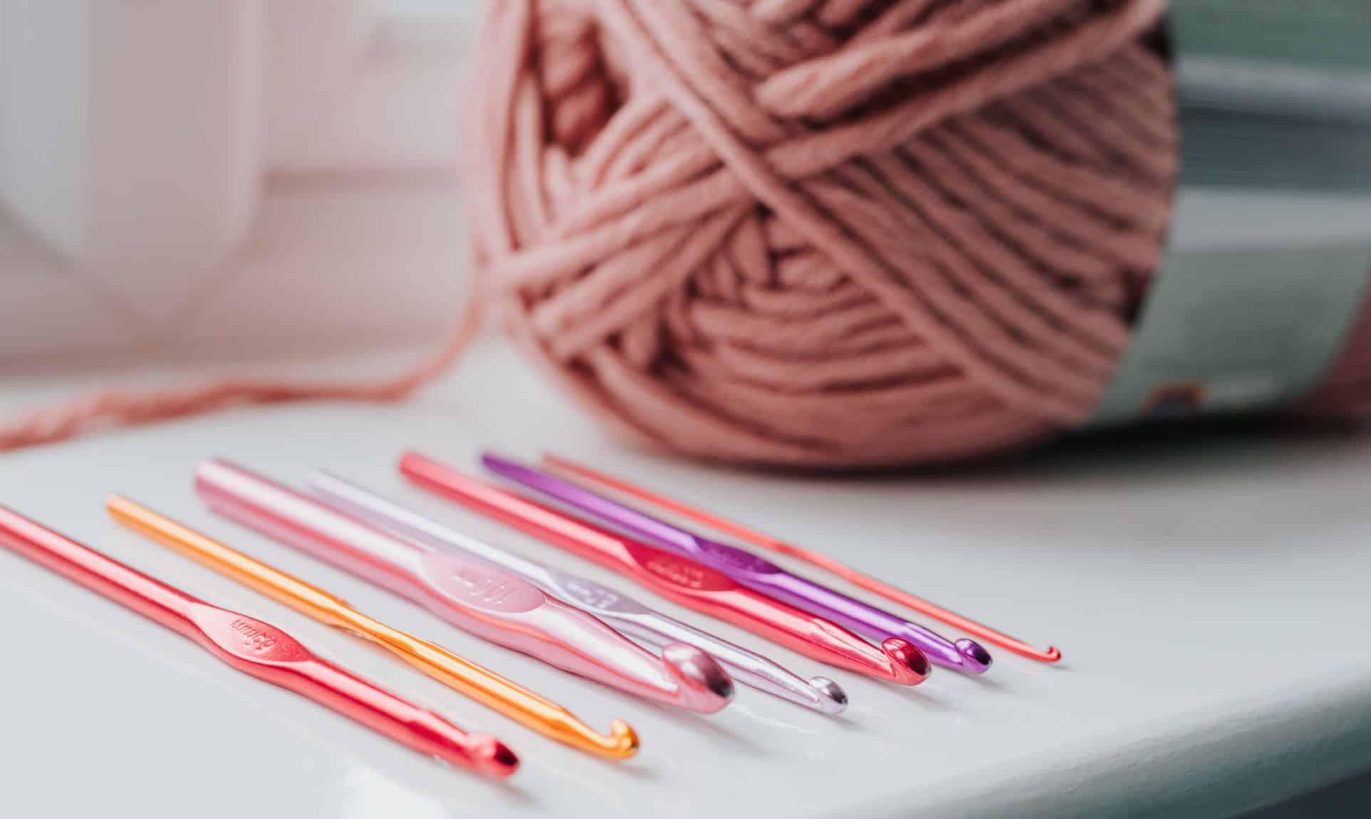 pink crochet needles and pink yarn